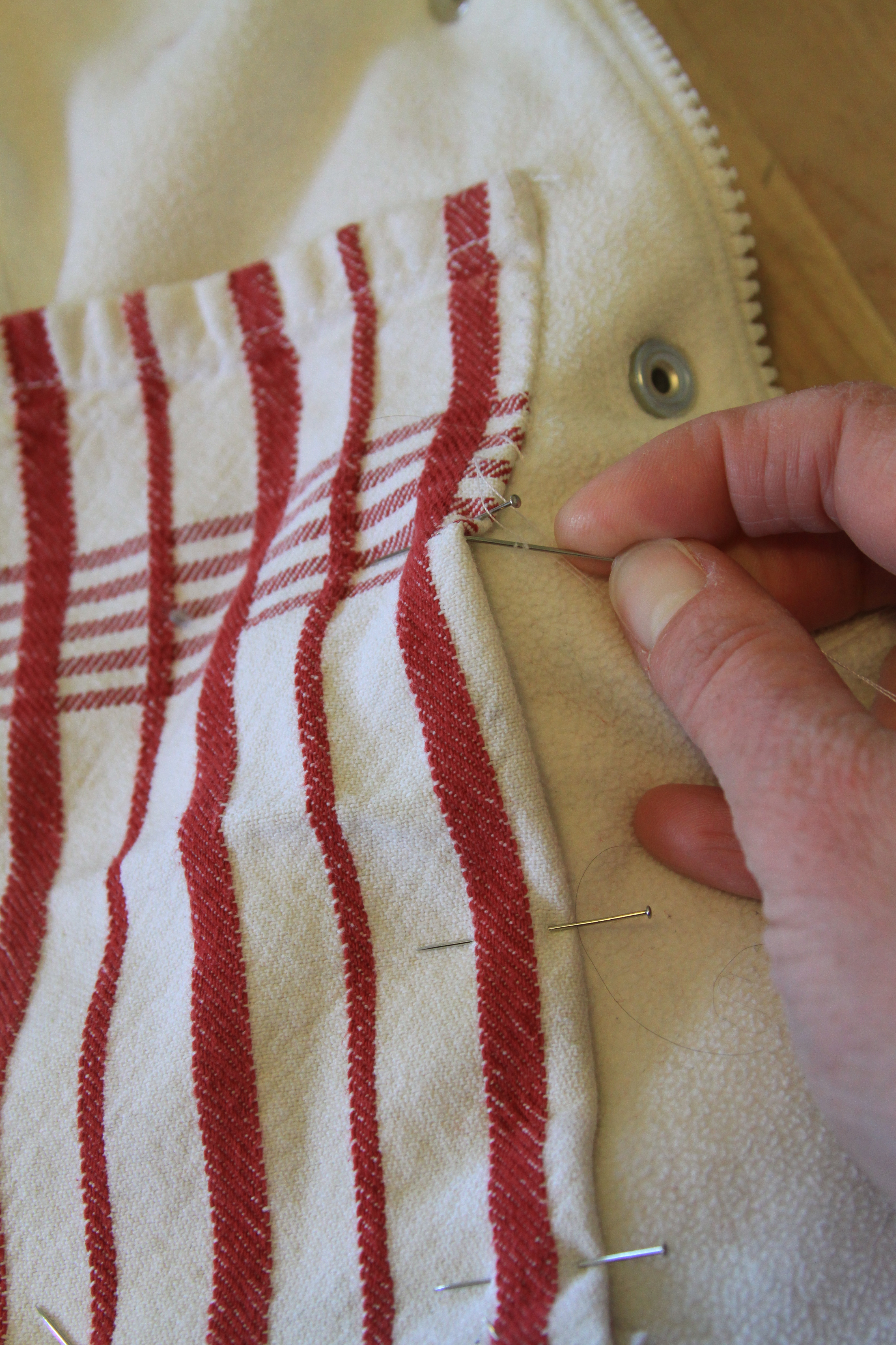 hand sew pocket to inner vest lining